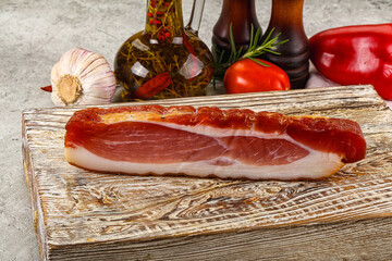 Piece prosciutto crudo over board
