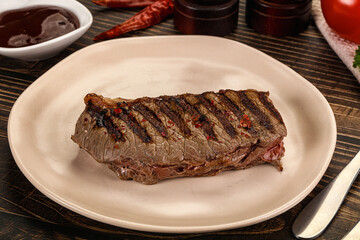 Grilled beef striploin steak with sauce