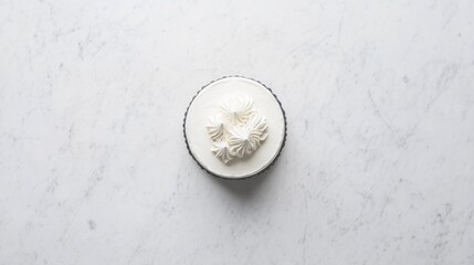 A top-down view of a decorated cake on a marble surface,