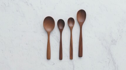 A rustic wooden spoon set arranged artistically on a marble countertop
