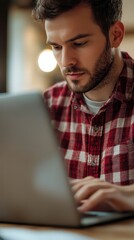 Focused Work: A close-up shot captures a focused individual engrossed in work, his eyes intently fixed on a laptop screen, epitomizing concentration and diligence in the digital workspace.