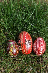 Traditional hand-dyed and hand-painted Easter eggs on the green grass in Poland called pisanka or kroszonka or kraszonka