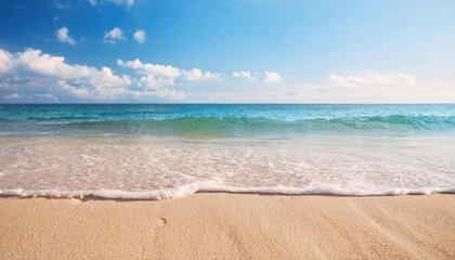 Obraz premium serene beach shoreline with gentle ocean waves and golden sand under a bright blue sky, perfect for travel and relaxation themes