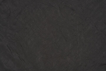 A close-up shot of a black synthetic fabric, showcasing its subtle texture and uniform dark color