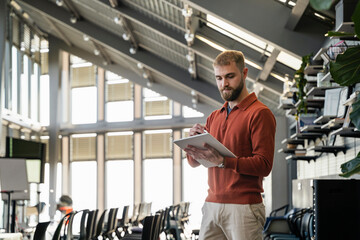 Young man using a tablet in a modern office setting