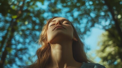 Low-angle view of a woman breathing in nature. 