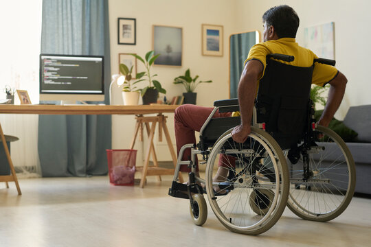 Remote worker with disability using wheelchair at home office