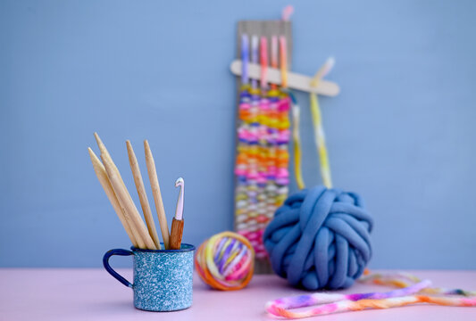 Colorful yarn and knitting tools in a studio