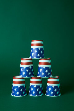 Stacked disposable cups with American flag design in a studio setting