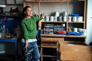 Small business owner in a creative workshop with art supplies