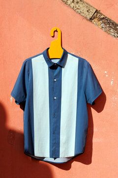 Vintage style bowling shirt hanging on a wall outdoors