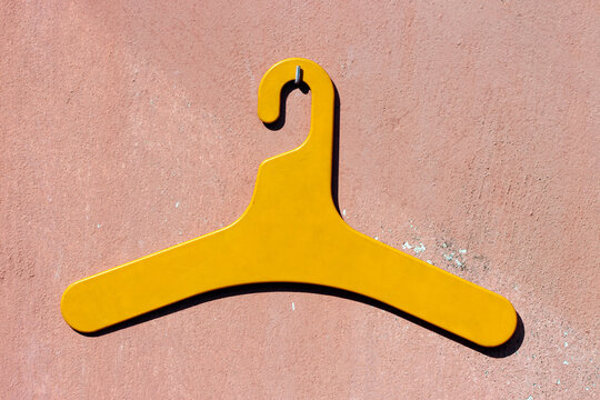 Yellow vintage style hanger on a textured wall