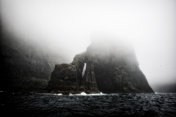 Misty cliffs of Mingulay, a remote abandoned island in Scotland's Western Isles, known for its rugged beauty and nesting Puffins