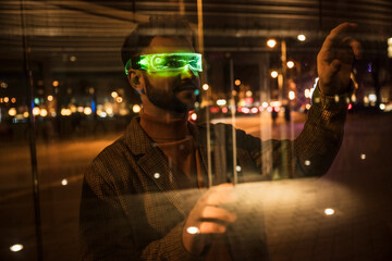 Smiling man wearing smart glasses seen through glass