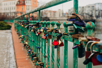 Love locks on a bridge railing in Wroclaw, Poland symbolizing romance and commitment