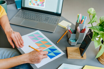 Designer working on graphic design at modern office desk