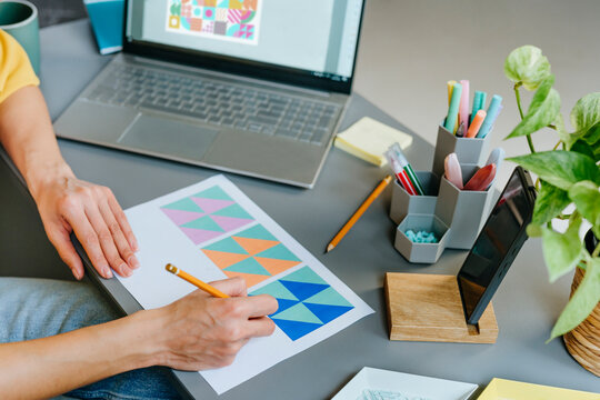 Designer working on graphic design at modern office desk - Powered by Adobe