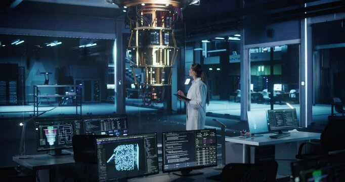 Female Computer Scientist Developing Quantum Machine Learning Algorithms, Using a Tablet Computer to Simulate and Test Their Performance. She is Standing in an Advanced Dark Office Alone