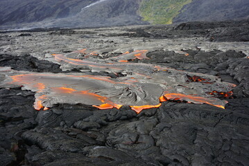 Hot magma flows  over old lava field