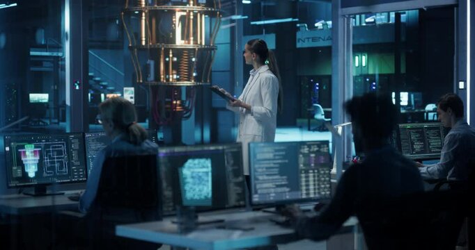 Diverse Team of Engineers Working in a Technological Research Center with AI Data and Software Code on Screens. Female Scientist in a Lab Coat Standing Next to a Quantum Computer with a Tablet