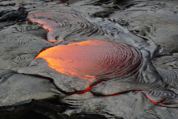 Hot magma flows  over old lava field