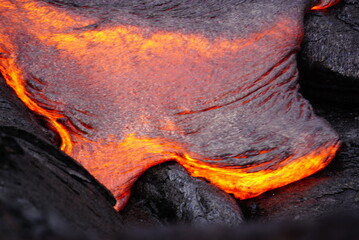 Hot magma flows  over old lava field