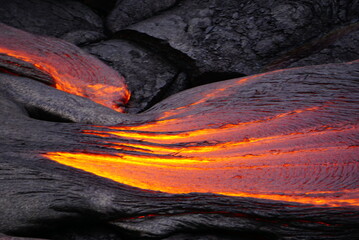 Hot magma flows  over old lava field