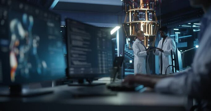 Female and Male Engineers Working in an Advanced Lab. Technician and Manager Discussing Quantum Computing Technology for Medical Research. Molecular Modelling Software Working on Computer Screen