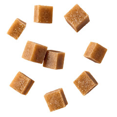 Caramel candies scattered on a white background. These sweet treats are perfect for snack, dessert, or confectionery visuals.