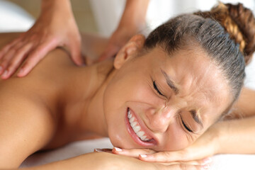 Woman suffering a massage in spa