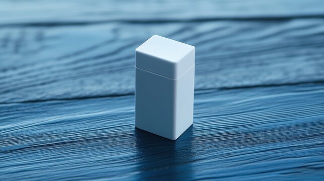 A pristine white dental floss case, adorned with a subtle blue design, sits proudly on a smooth, textured blue wooden surface, inviting text or design to complement its minimalist elegance.
