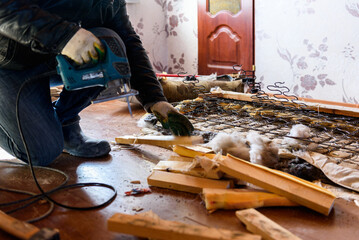 Getting rid of old things. Disassembling an old sofa in the attic.