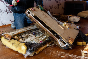 Getting rid of old things. Disassembling an old sofa in the attic.