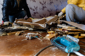 Getting rid of old things. Disassembling an old sofa in the attic.