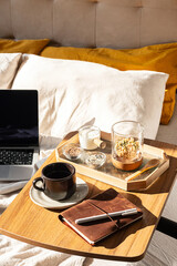 Remote Working in Bed with Laptop, Some Food and Coffee Cup.