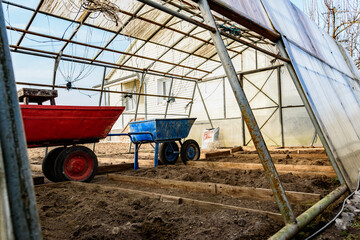 Repair of an old greenhouse on a spring day, greenhouse renovation.