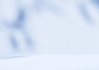 Empty blue room studio with shadow of leaves on concrete wall and floor for product presentation. Sunlight effect shadow. Minimal winter backdrop. Cosmetic, beauty and fashion showroom.