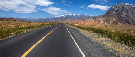 A long road with a yellow line down the middle