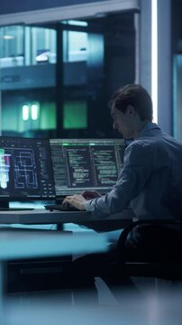 Vertical Screen: Young Software Developer Working Behind a Desk on a Computer. Engineer Optimizing Software Code of a Quantum Processor, Building a Visual Model of the Quantum Computing Architecture
