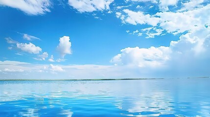 Obraz premium Blue sky and white clouds, calm water surface.