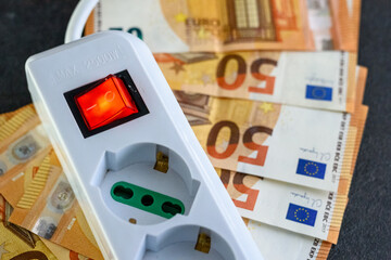 Expensive bills. Light bulb with banknotes indicate inflation and rising electricity bills....