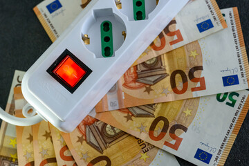 Expensive bills. Light bulb with banknotes indicate inflation and rising electricity bills....