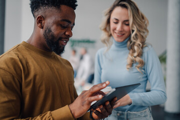 Business colleagues using digital tablet in modern office