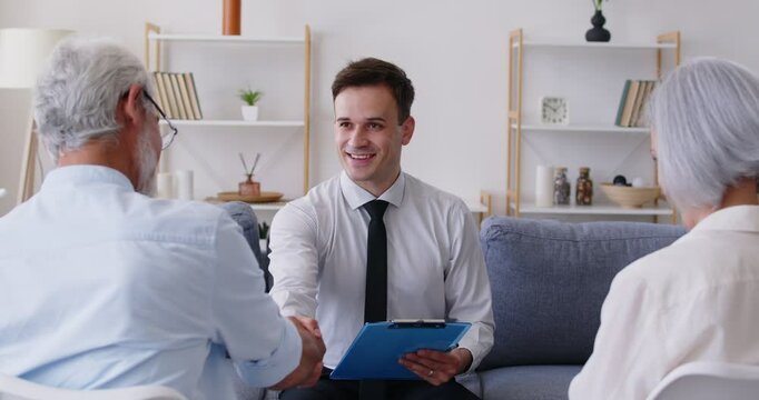 Happy businessman shaking hands with elderly couple, close-up. Senior people signing contract with financial consultant. Concept life insurance, financial advisor, retirement planning