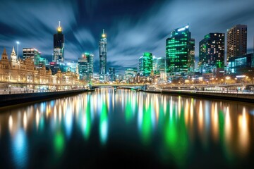 Fototapeta premium Festive night skyline with green illuminated cityscape under cloudy sky by water