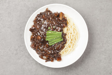 Jjajangmyeon is one of Chinese dishes. The noodles are mixed with Chinese soybean paste stir-fried with meat and vegetables.