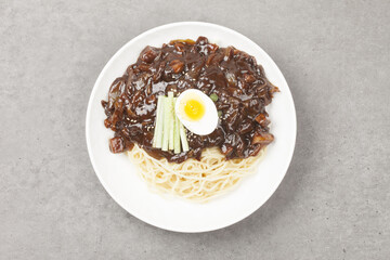 Jjajangmyeon is one of Chinese dishes. The noodles are mixed with Chinese soybean paste stir-fried with meat and vegetables.