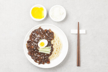Jjajangmyeon is one of Chinese dishes. The noodles are mixed with Chinese soybean paste stir-fried with meat and vegetables.