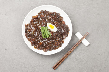 Jjajangmyeon is one of Chinese dishes. The noodles are mixed with Chinese soybean paste stir-fried with meat and vegetables.