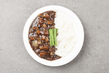 A food made by frying meat, potatoes, pumpkin, and onions in Chinese soybean paste and putting the sauce on top of rice.
